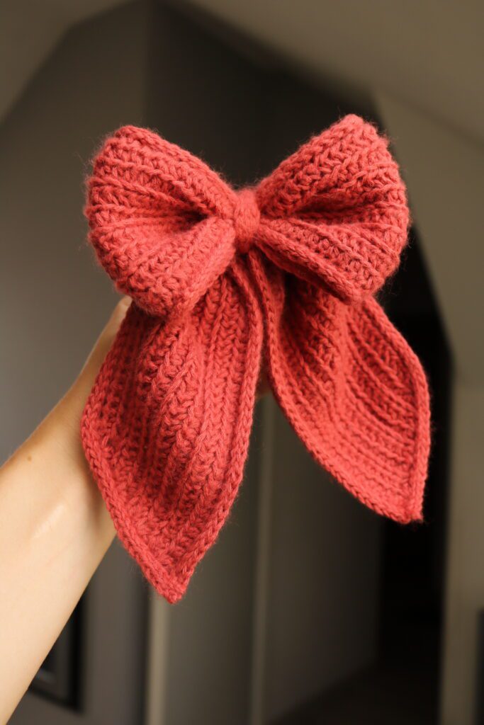 Close-up of a textured crochet bow with neat folded center