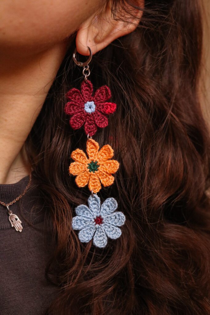 Close-up of the dangling crochet flower earring detail