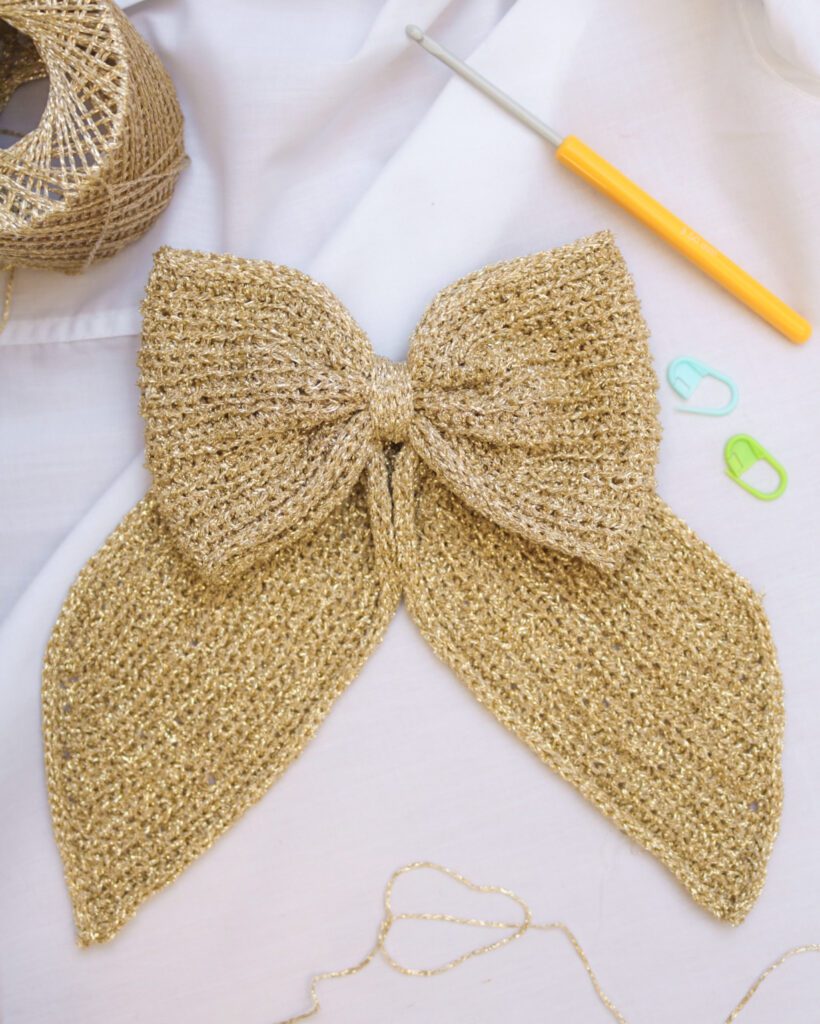 Close-up of a textured crochet bow with neat folded center