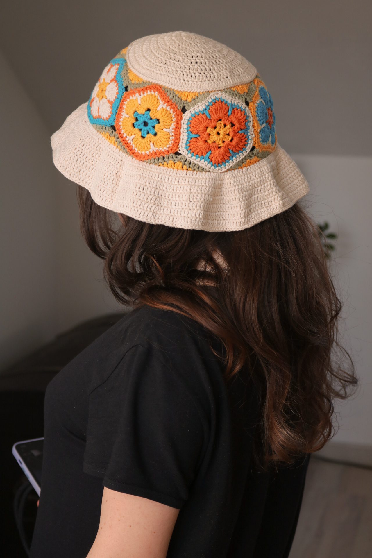 Crochet bucket hat made from African flower hexagons, worn at an angle