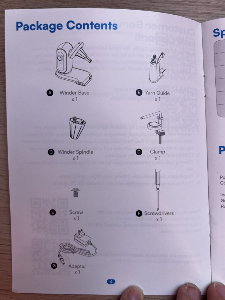 The Caydo A1 Pro Max manual open at the package contents page, listing the winder base, yarn guide, winder spindle, clamp, screw, screwdriver and adapter