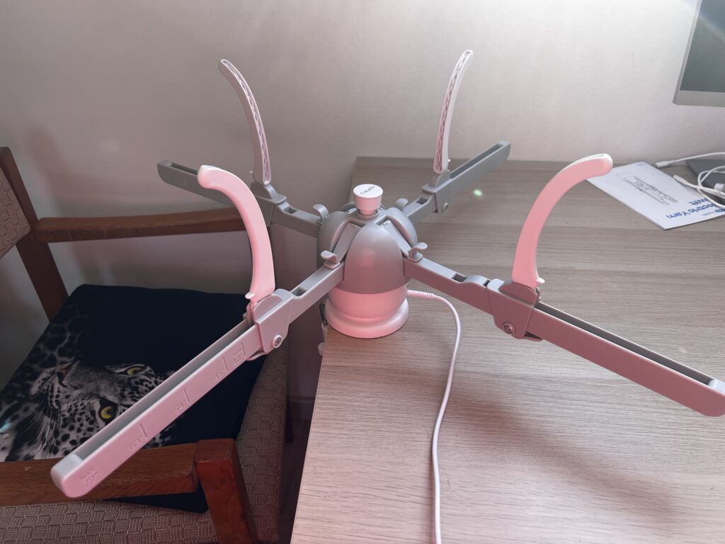 The Caydo Y1 Pro electric yarn swift set up on a table with its four arms extended, ready to hold a skein of reclaimed yarn